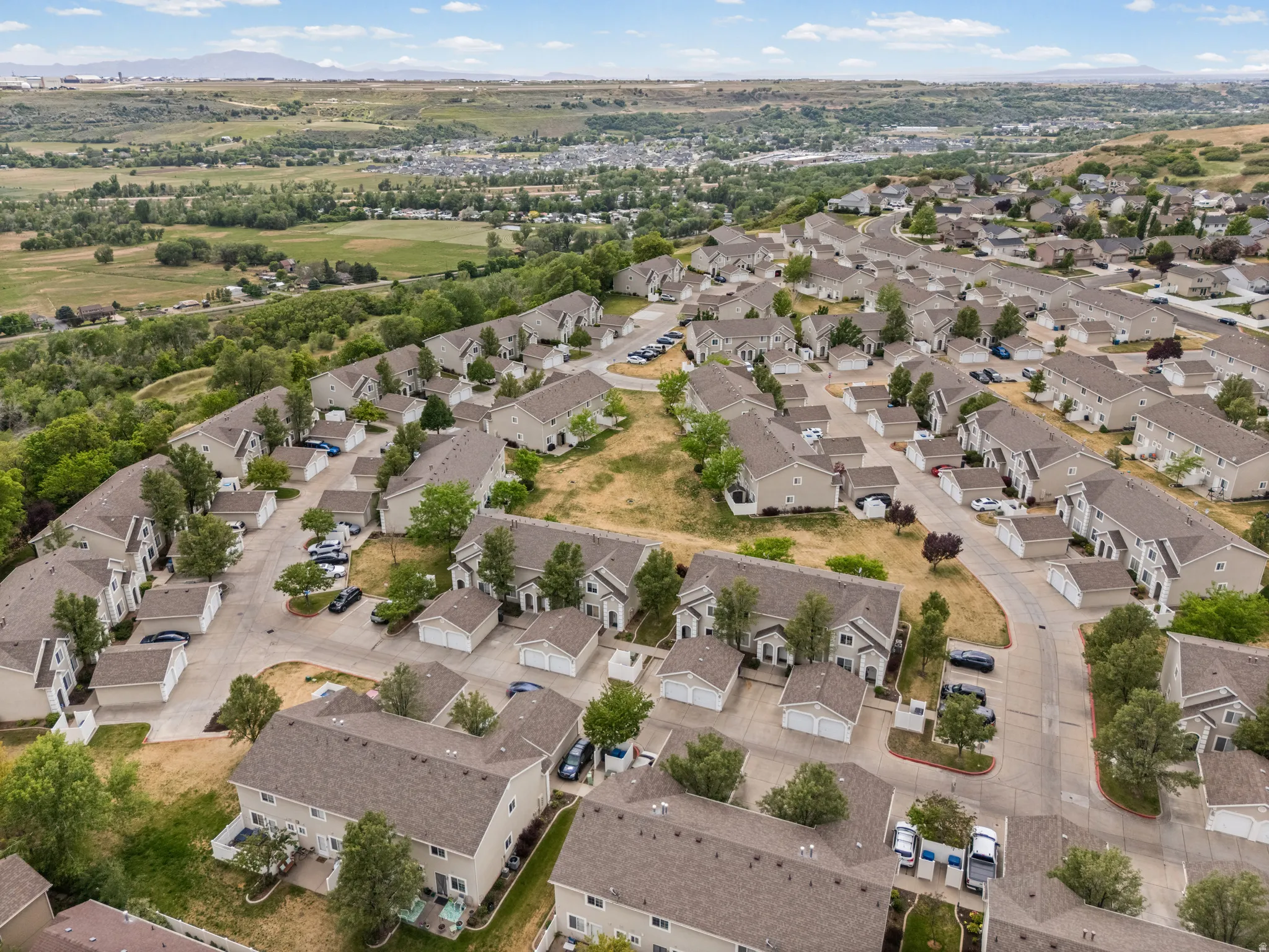 Residential community featuring multiple townhouse-style properties, each with individual garages