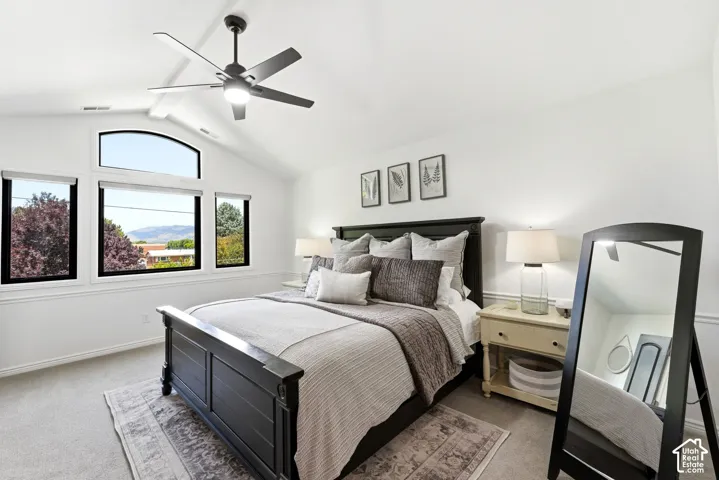 Vaulted ceiling featuring a ceiling fan with integrated lighting