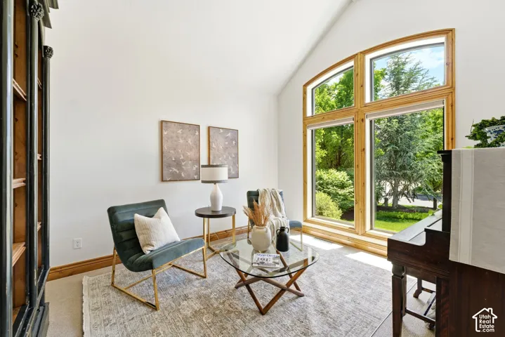 Vaulted ceiling with a large arched window featuring natural wood trim