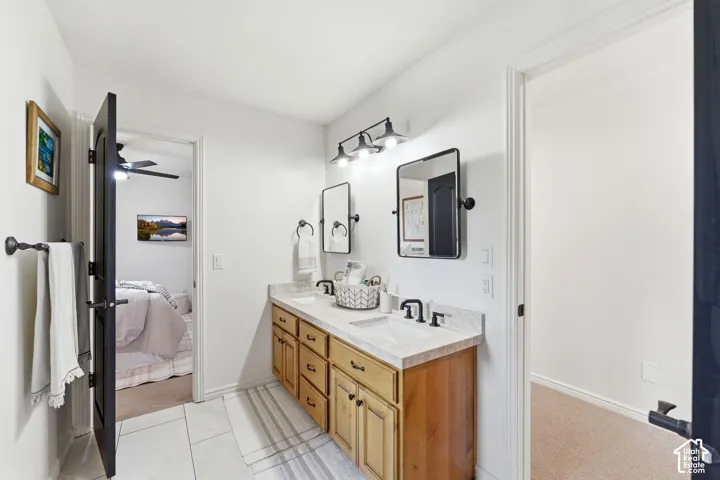 Double vanity featuring light-toned cabinetry and light-colored countertops