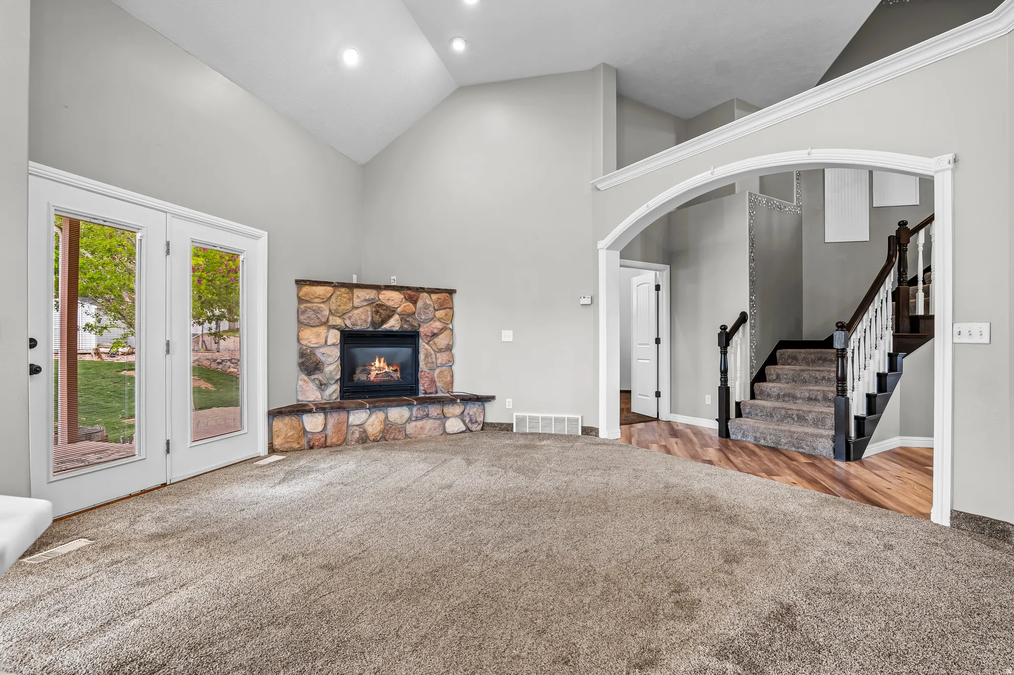 Great room with vaulted ceilings and recessed lighting