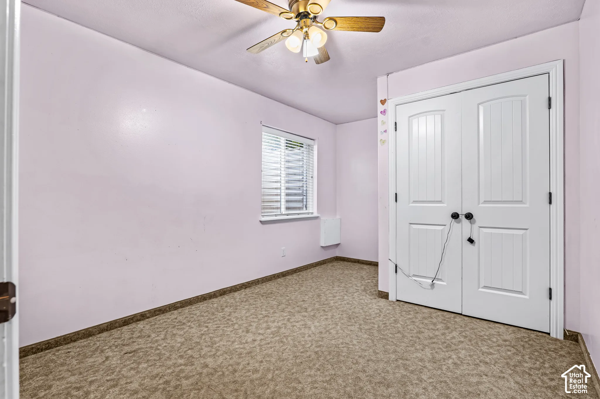 Room featuring neutral patterned carpeting and light-toned walls