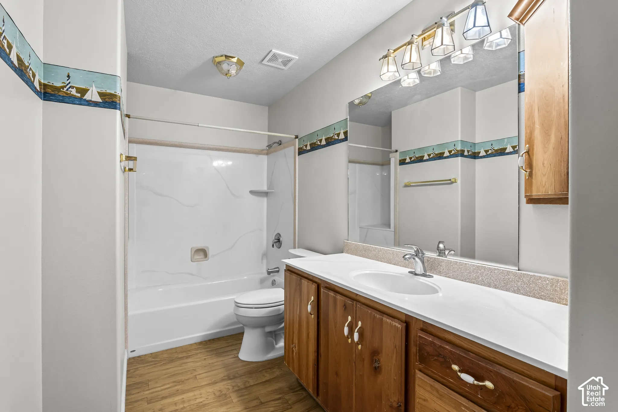 Full bathroom featuring a single vanity with wood cabinetry and a white countertop