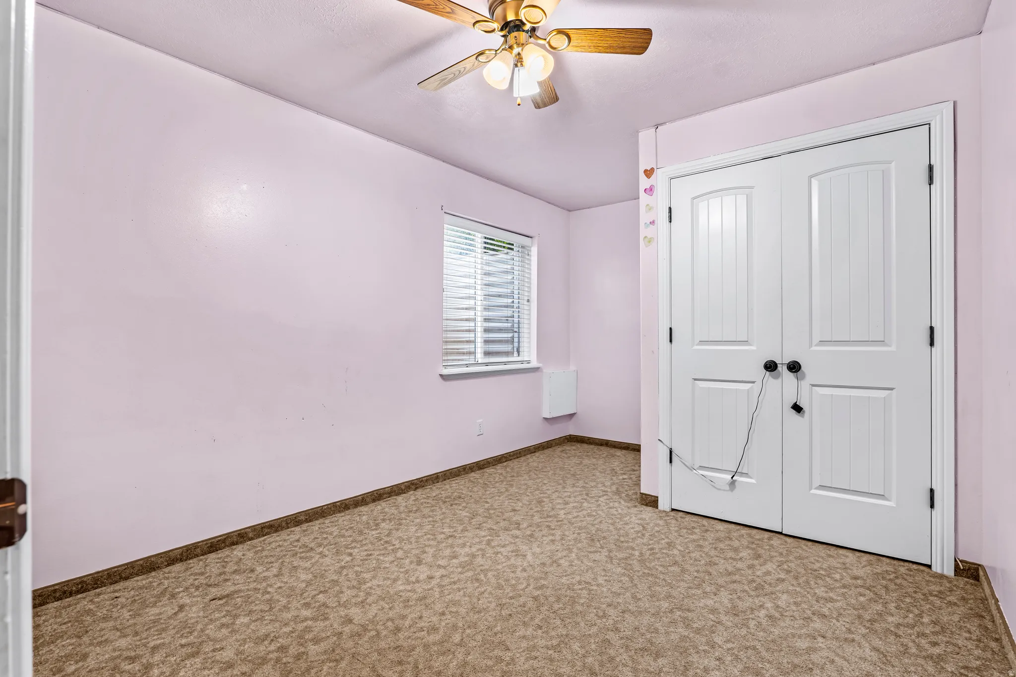 Room featuring neutral patterned carpeting and light-toned walls