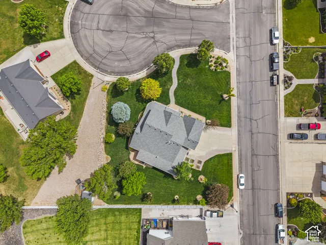 Aerial perspective showcasing a residential property with a multi-gabled roof and a well-maintained lawn