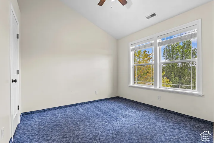 Room featuring a vaulted ceiling and dual pane windows