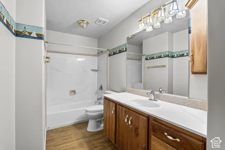 Full bathroom featuring a single vanity with wood cabinetry and a white countertop