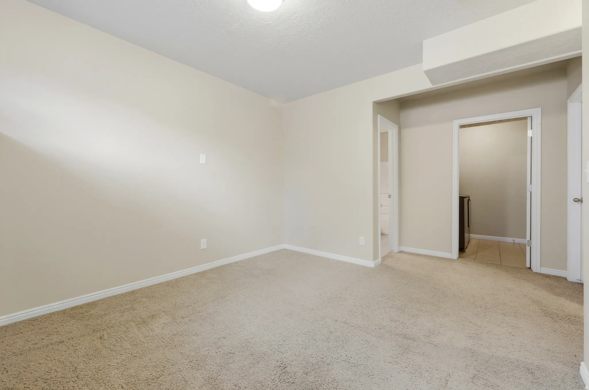 Bonus room looking into laundry, bathroom and utilities room