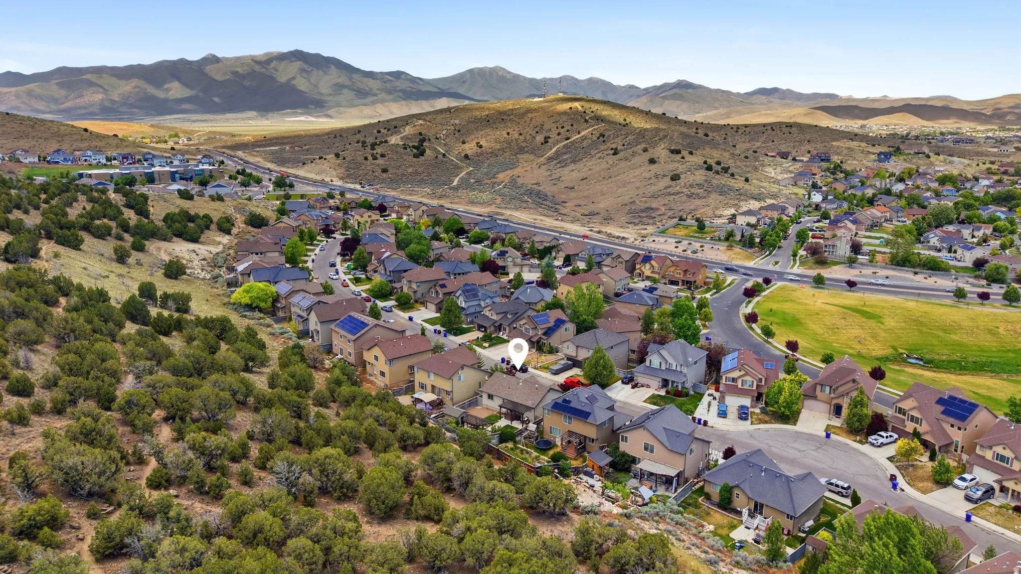 Residential neighborhood nestled into a hillside landscape with desert vegetation