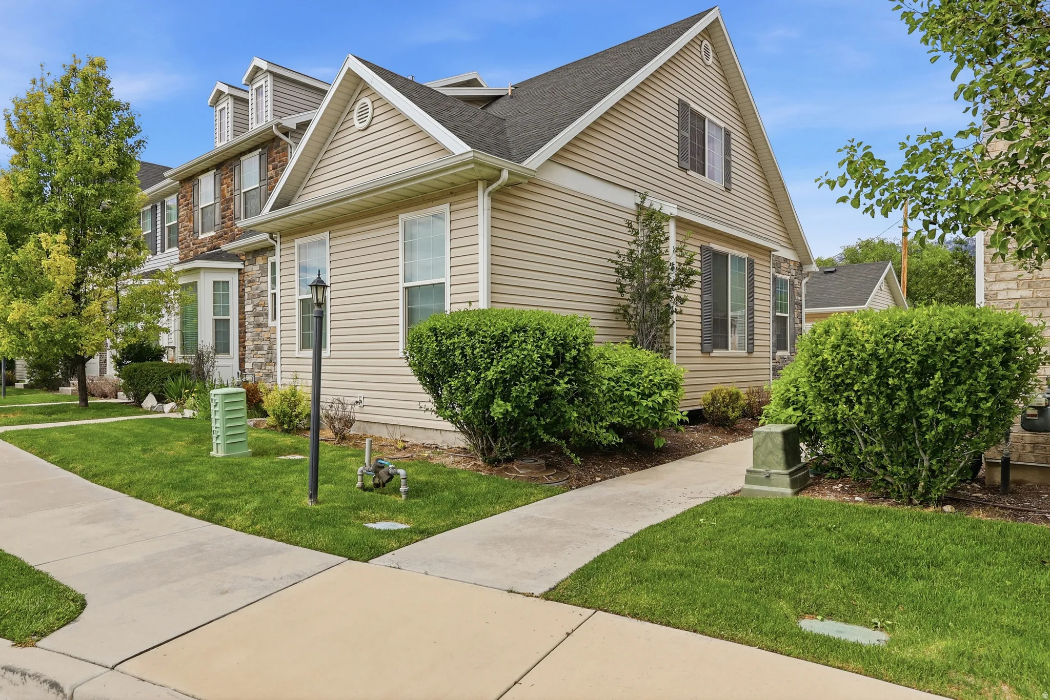 Beige horizontal siding exterior with dark shutters