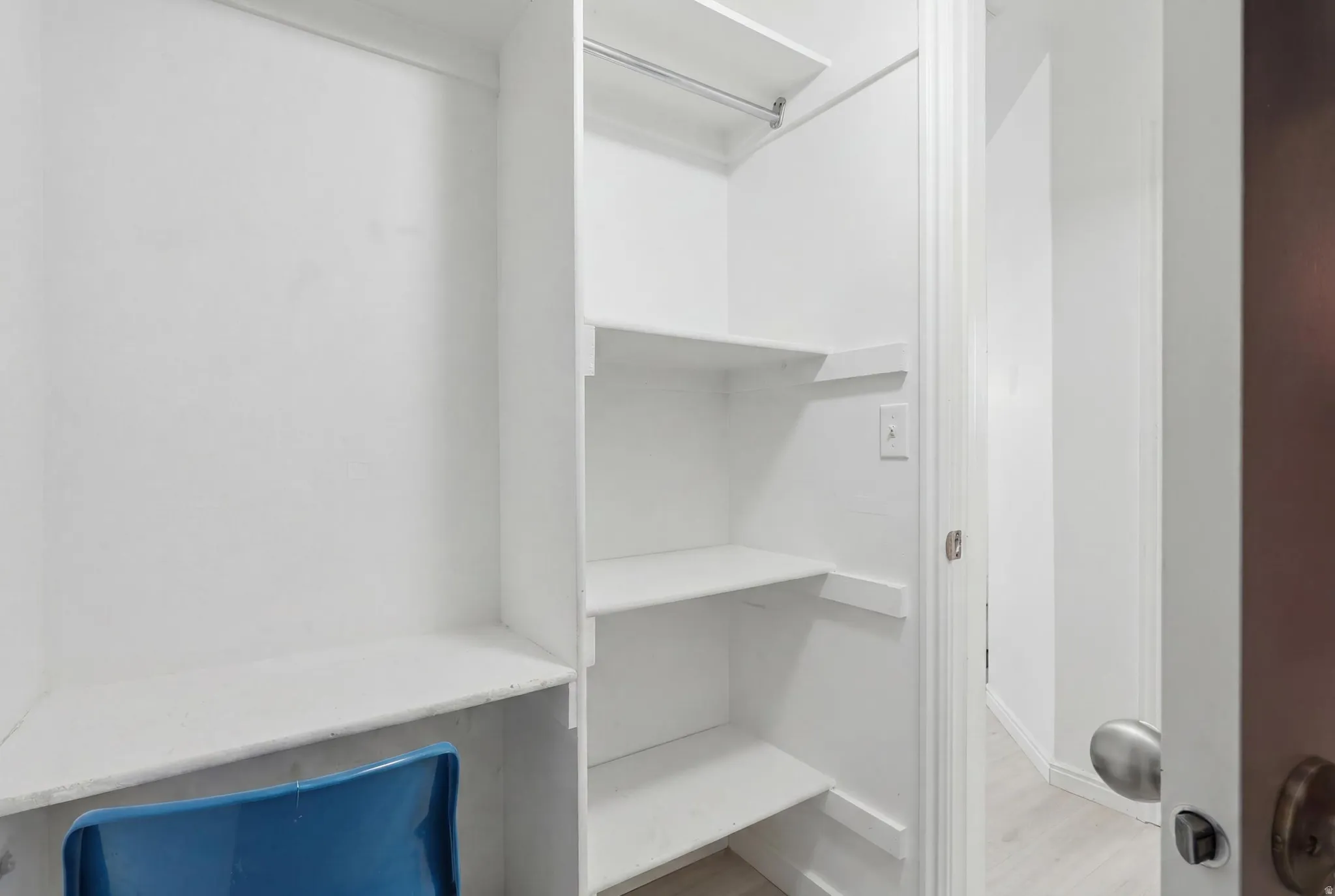 Built-in closet shelving system featuring multiple storage levels and a hanging rod