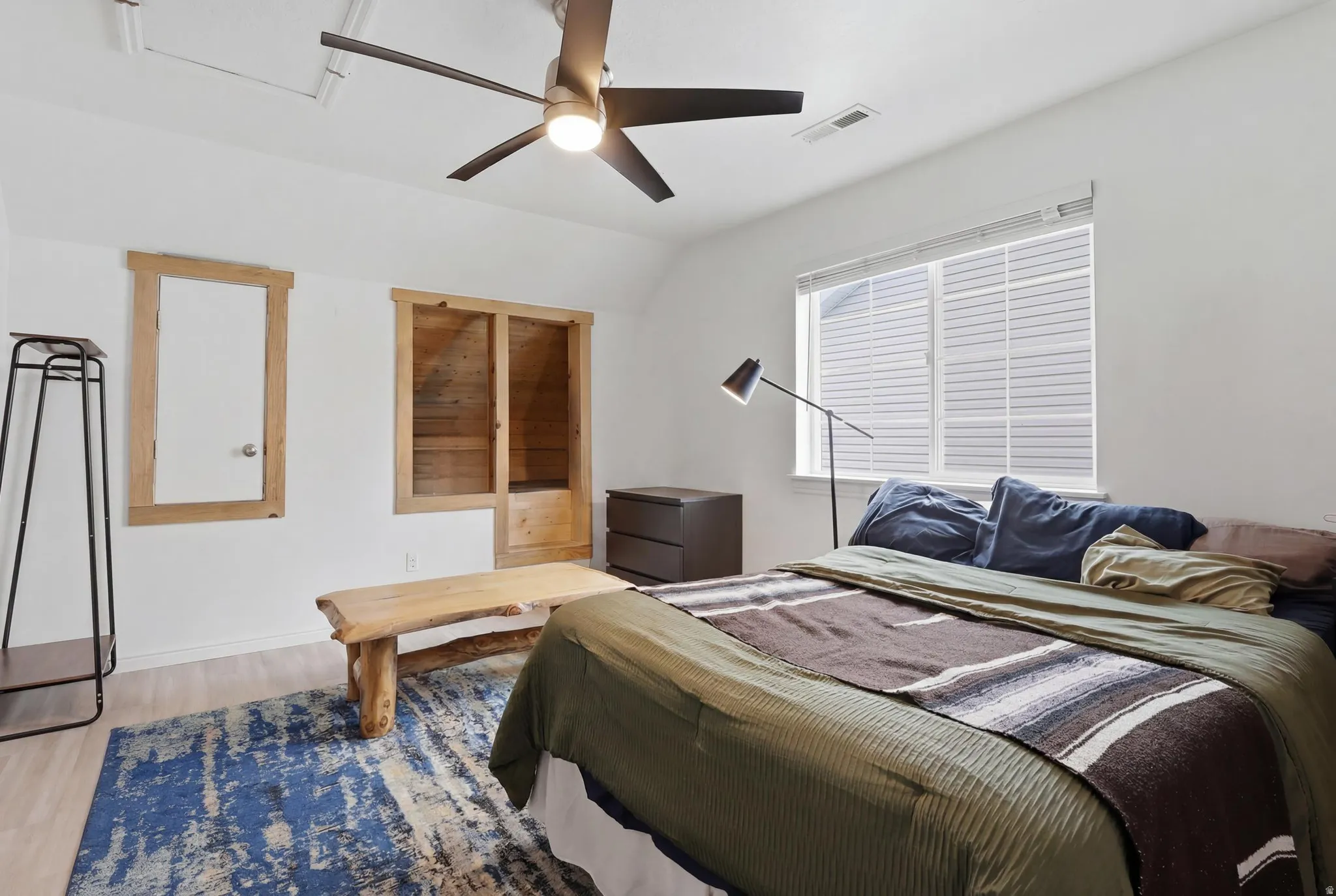 Room featuring light-toned wood-finish flooring and a ceiling fan with integrated lighting