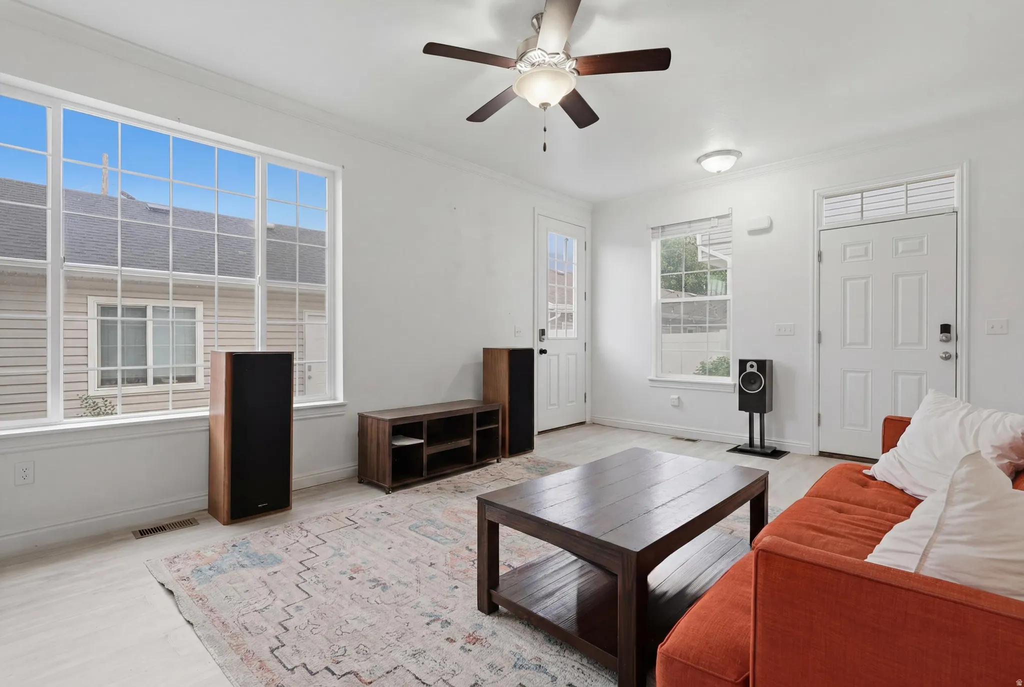 Bright living area featuring wood-finish flooring and white walls
