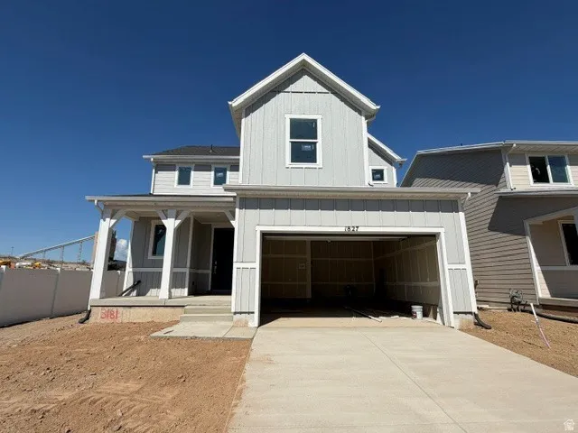 Modern two-story residence featuring light gray siding and white trim