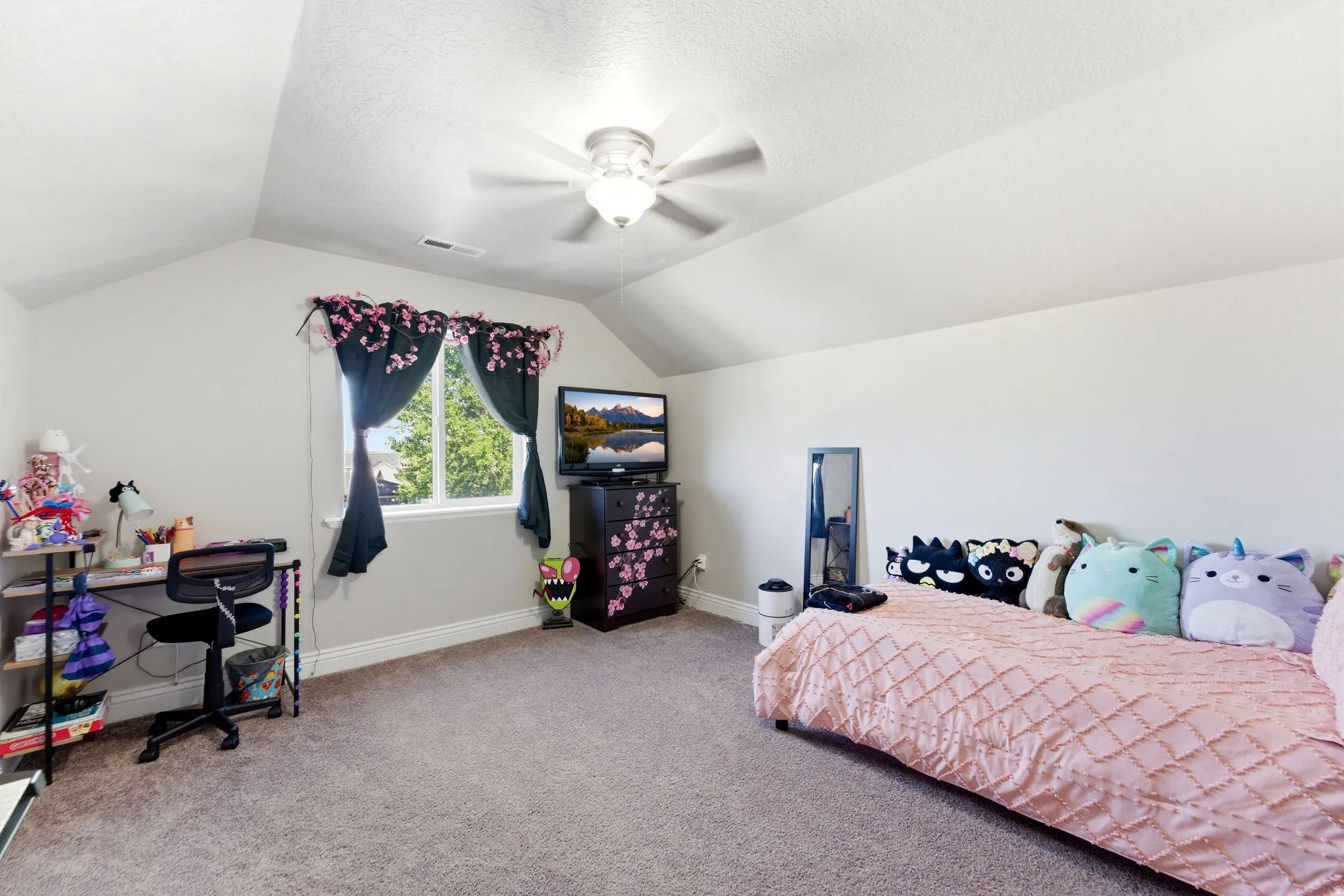 Room featuring vaulted ceilings and a ceiling fan