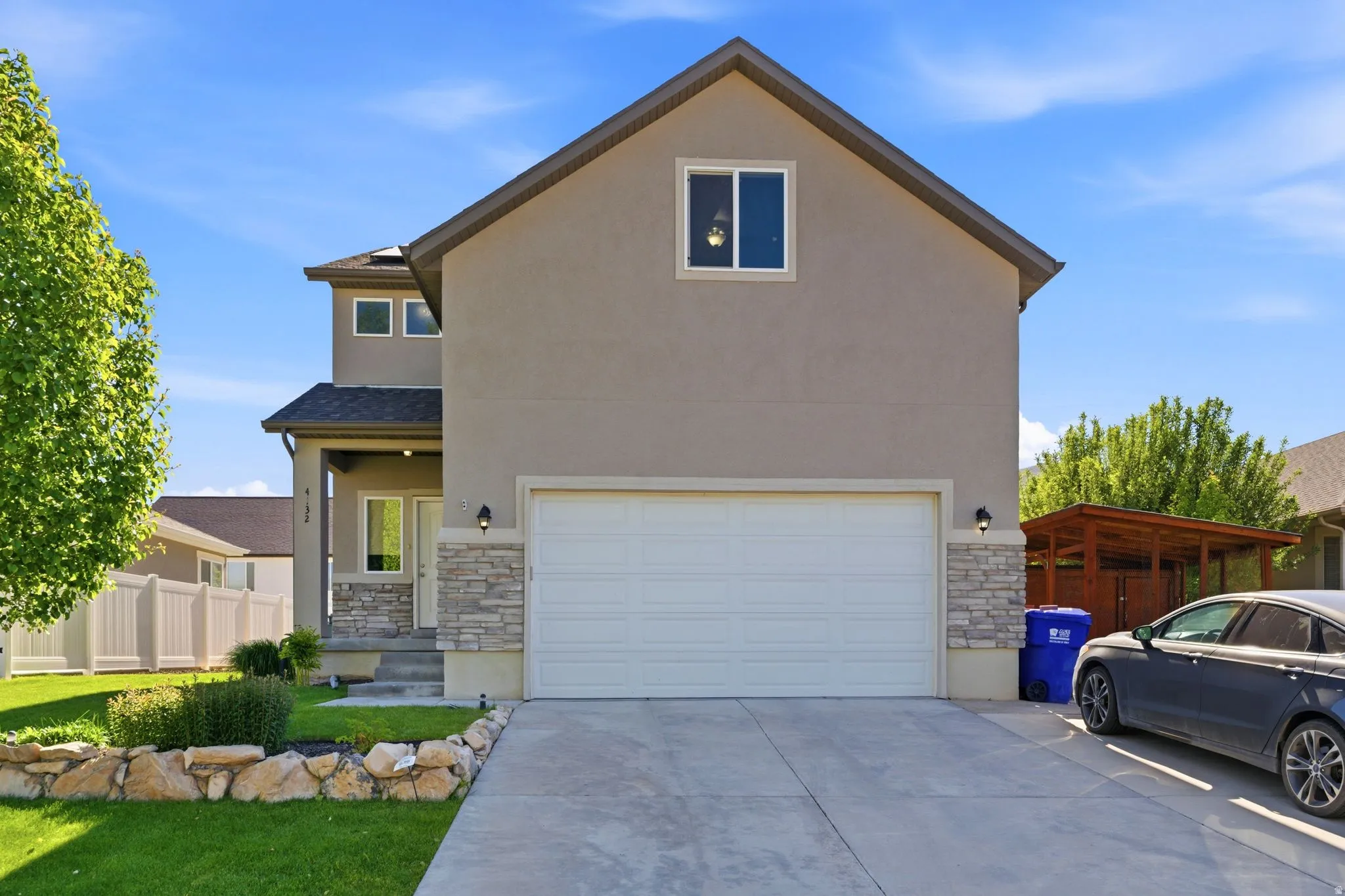 Contemporary stucco exterior with stone accents