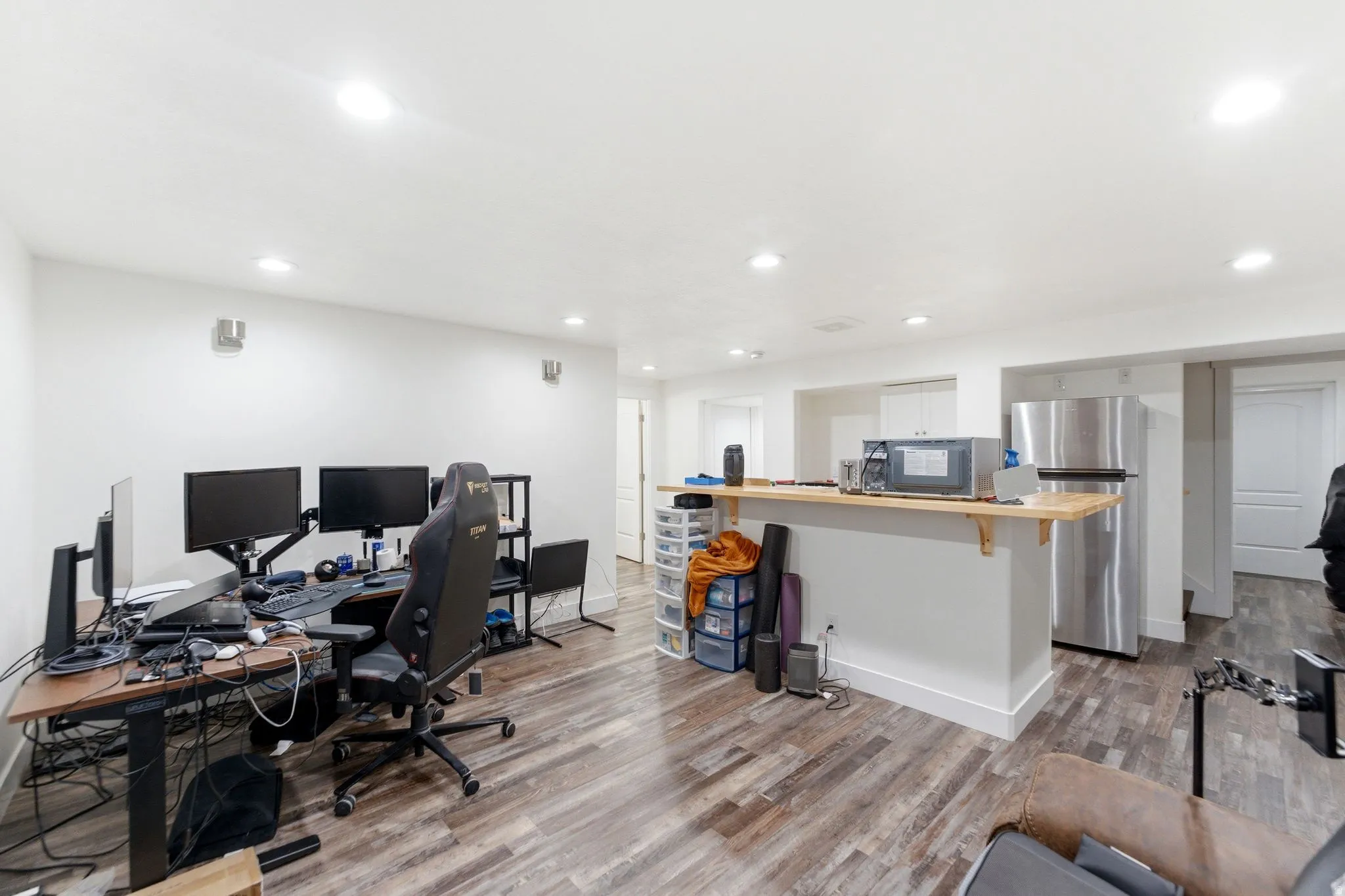 Open concept room featuring wood-finish flooring and recessed lighting