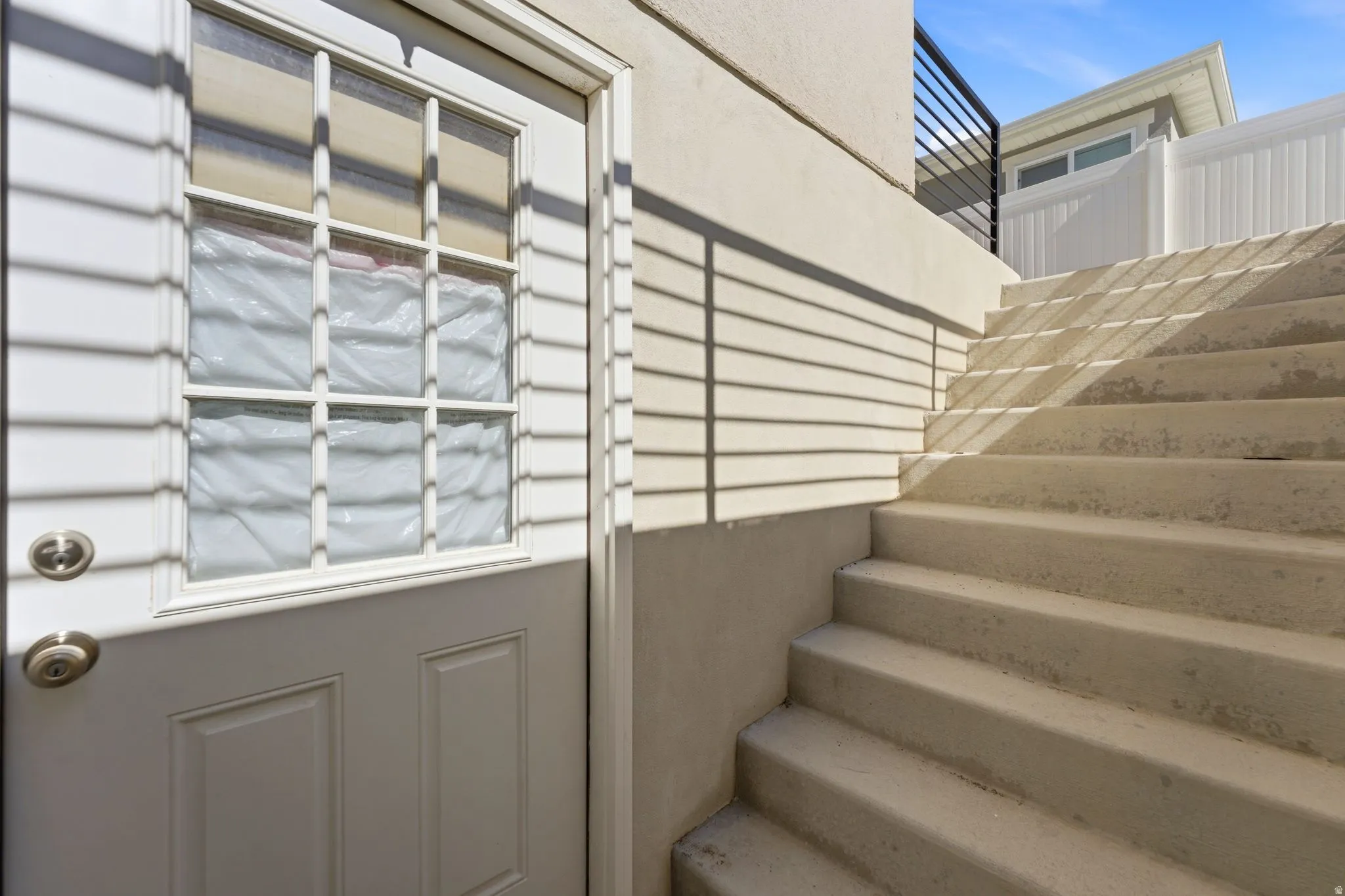 White paneled exterior door with upper window panes