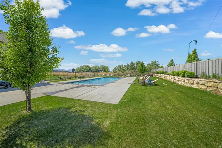 Community pool with lots of lawn area
