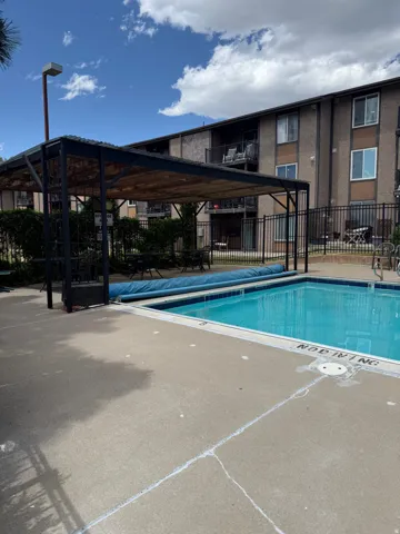 Outdoor swimming pool with surrounding concrete patio