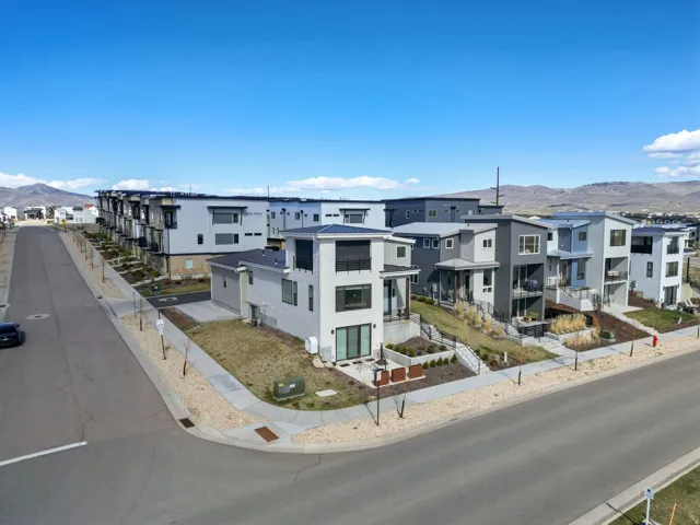 Modern residential community featuring multi-level facades with balconies and extensive window arrays