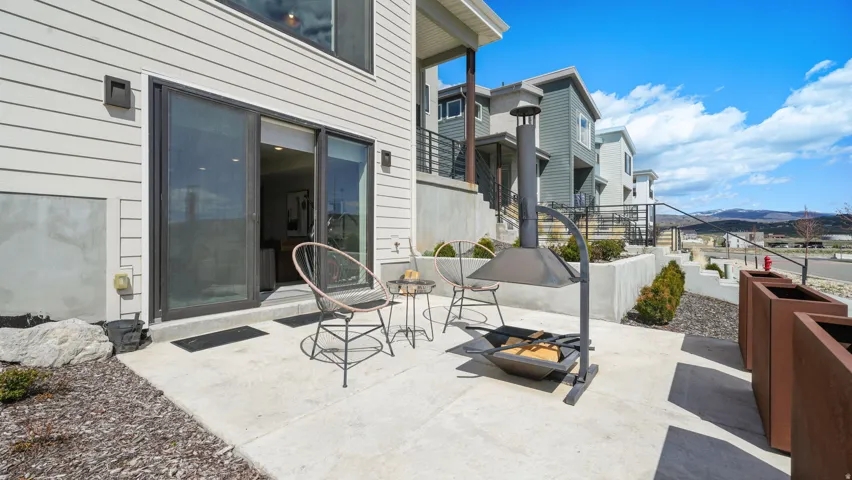 Concrete patio featuring a modern fire pit