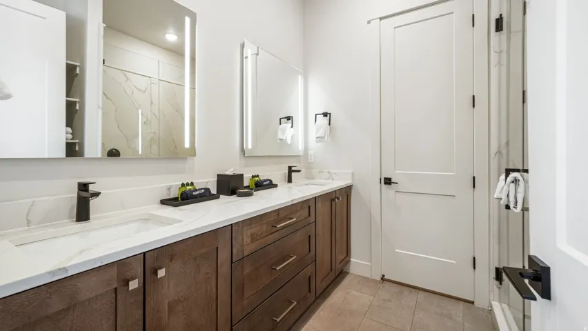 Dual vanity with integrated sinks and white marble-look countertops