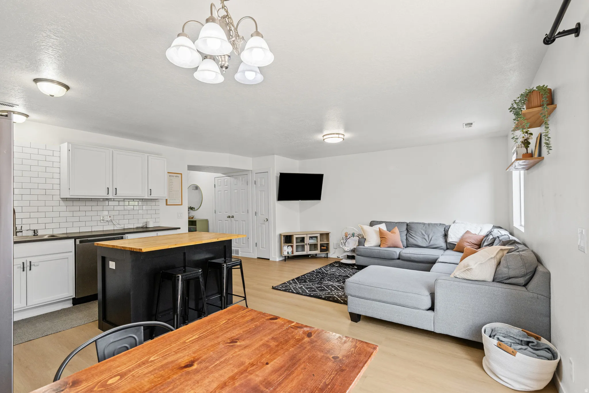 Open-concept living area featuring light wood-finish flooring