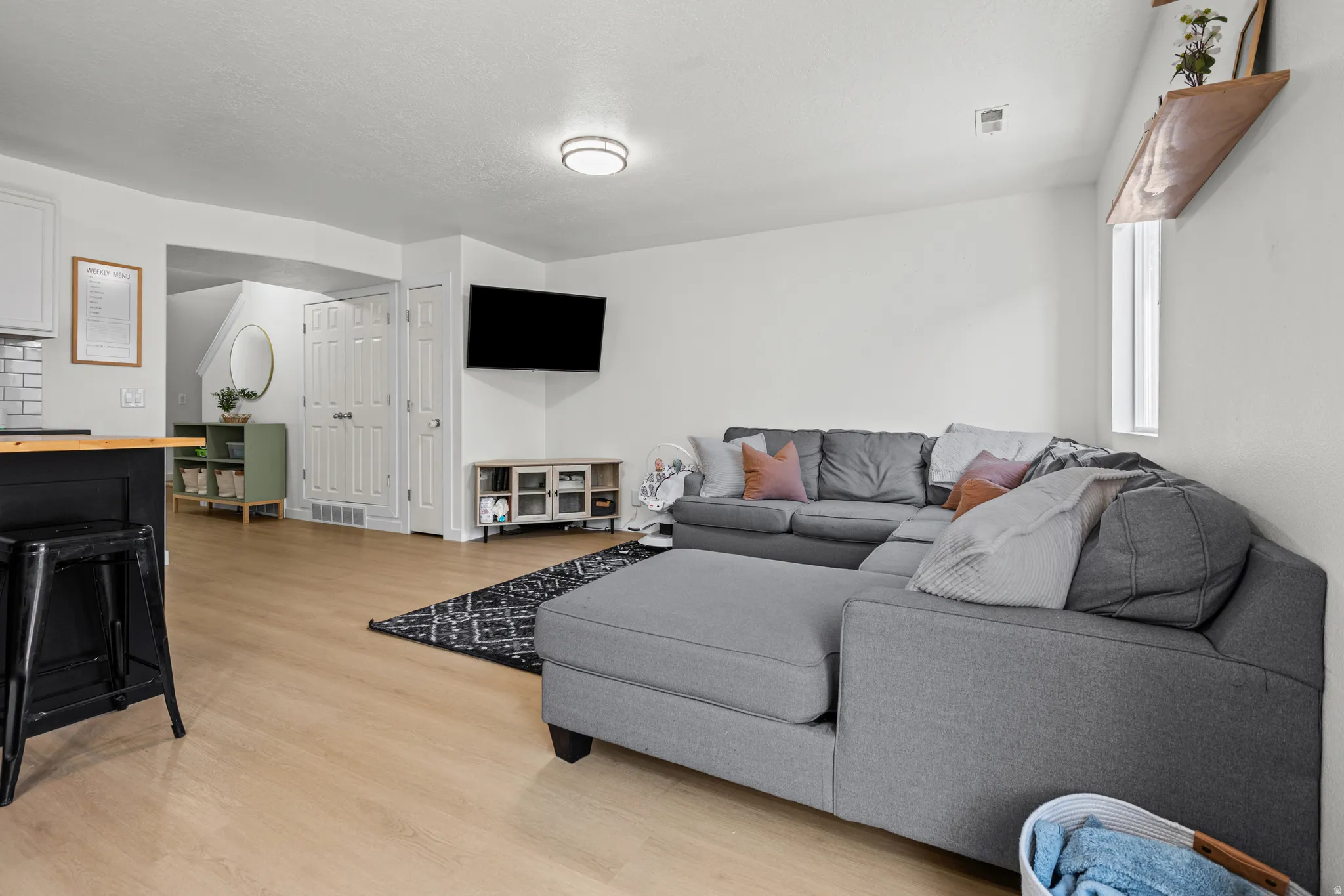 Open-concept living area with light wood-finish flooring