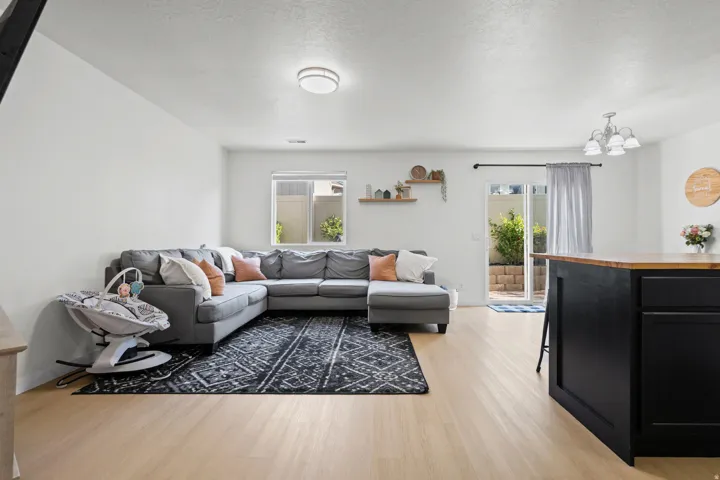 Open concept living area featuring light wood-finish flooring, white walls, and recessed lighting