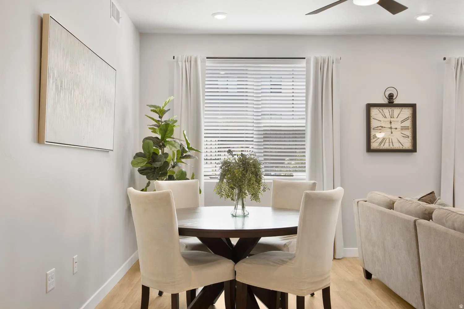 Dining area featuring a dark-finish round table, light-tone flooring, recessed lighting, a ceiling fan, and white window blinds