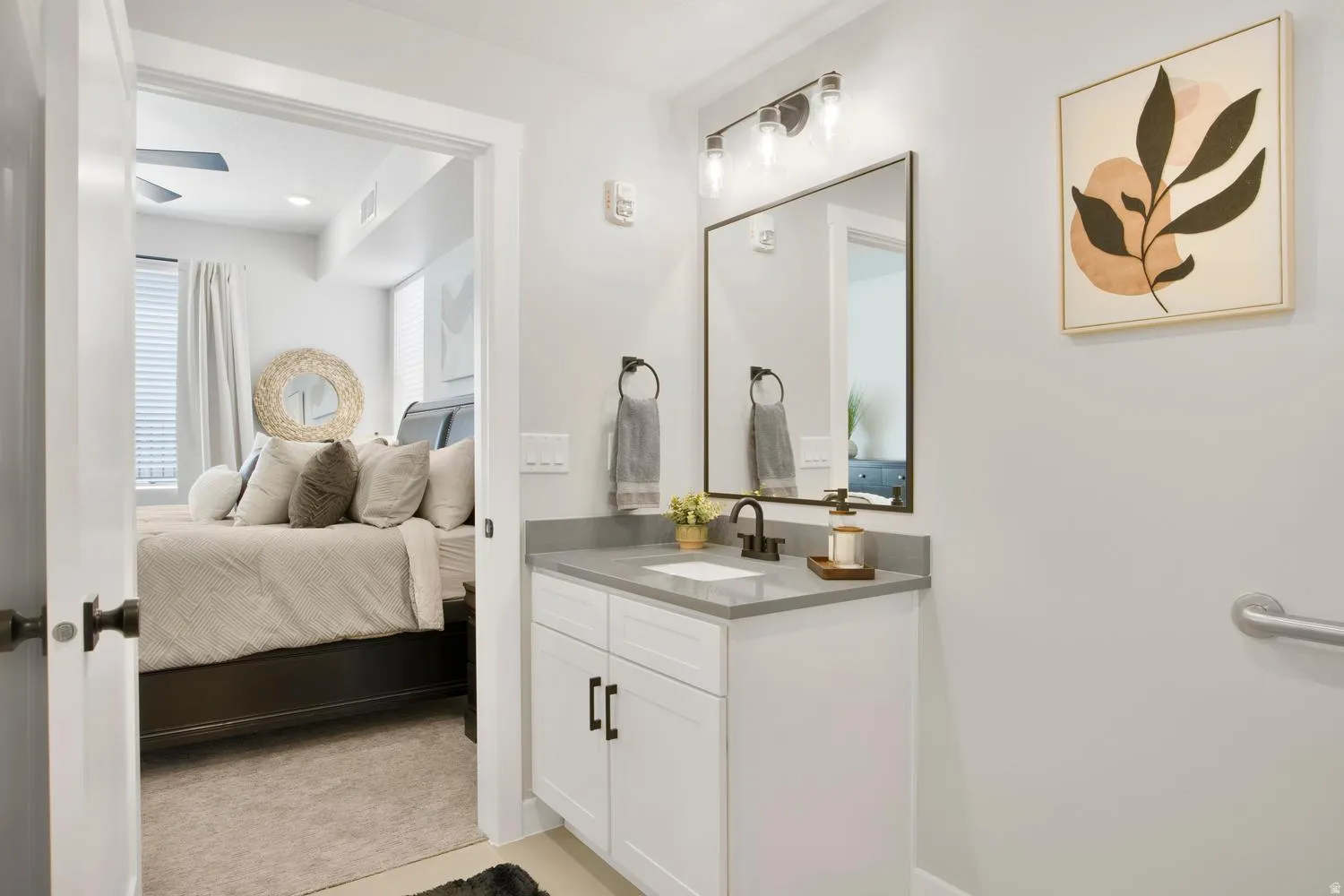 Bathroom vanity featuring a rectangular undermount sink, a gray countertop, and a matte black single-handle faucet