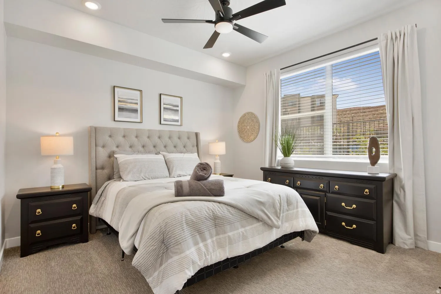 Bedroom featuring a tufted upholstered headboard, recessed lighting, and a ceiling fan