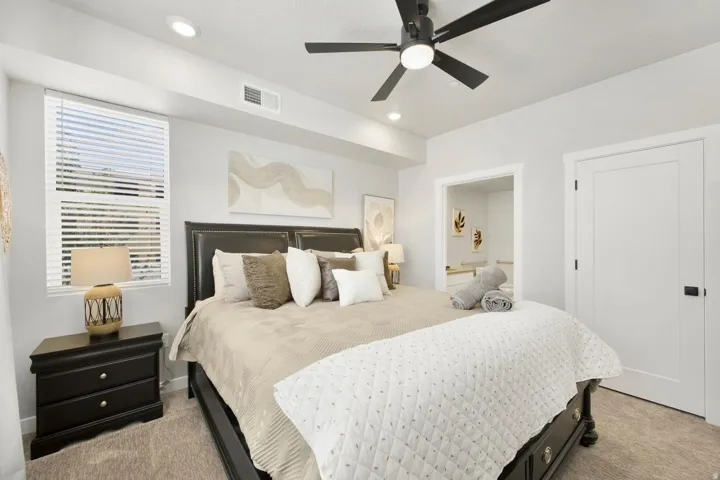 Carpeted room featuring a ceiling fan with integrated lighting, recessed lighting, and a window with blinds