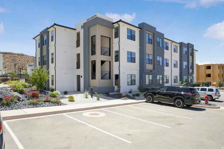 Modern multi-story building featuring a white and dark gray facade with contrasting horizontal siding