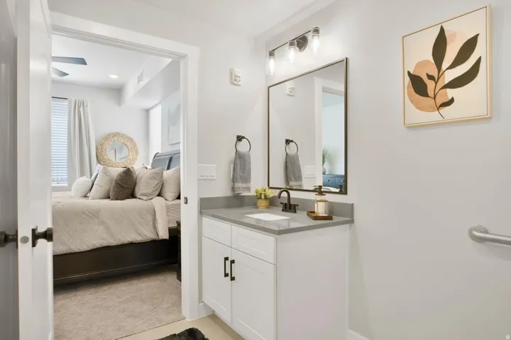 Bathroom vanity featuring a rectangular undermount sink, a gray countertop, and a matte black single-handle faucet