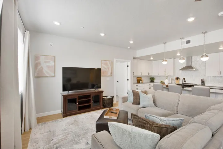 Open concept living space featuring recessed lighting and light wood-finish flooring