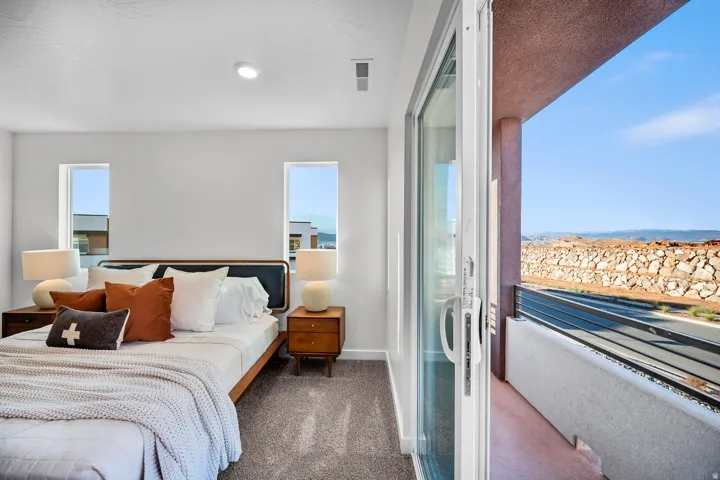 Bedroom featuring carpet flooring and two vertical windows