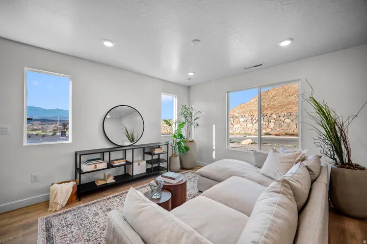 Bright living area featuring wood-finish flooring and recessed lighting