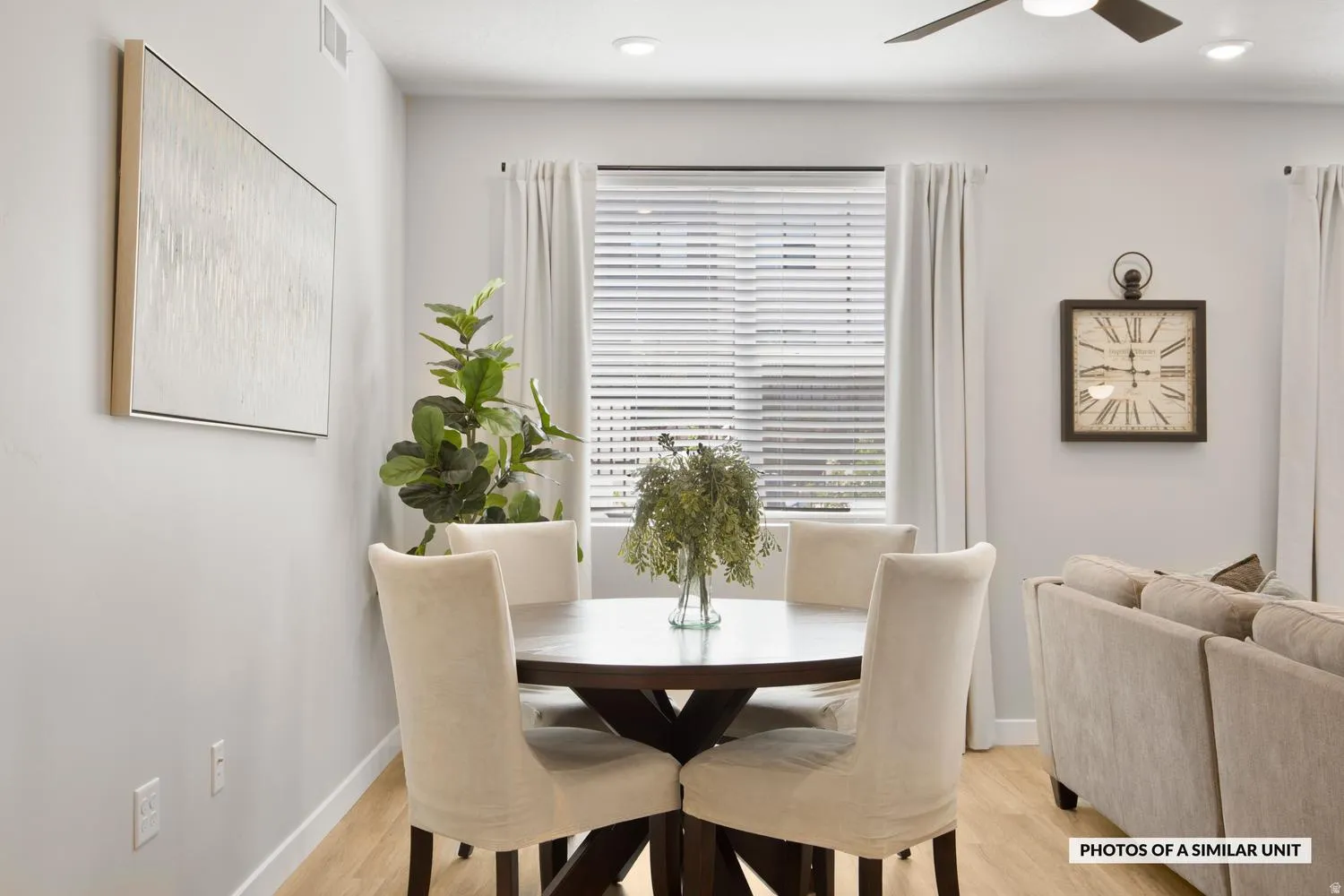 Open-concept dining area featuring wood-finish flooring, recessed lighting, and a ceiling fan