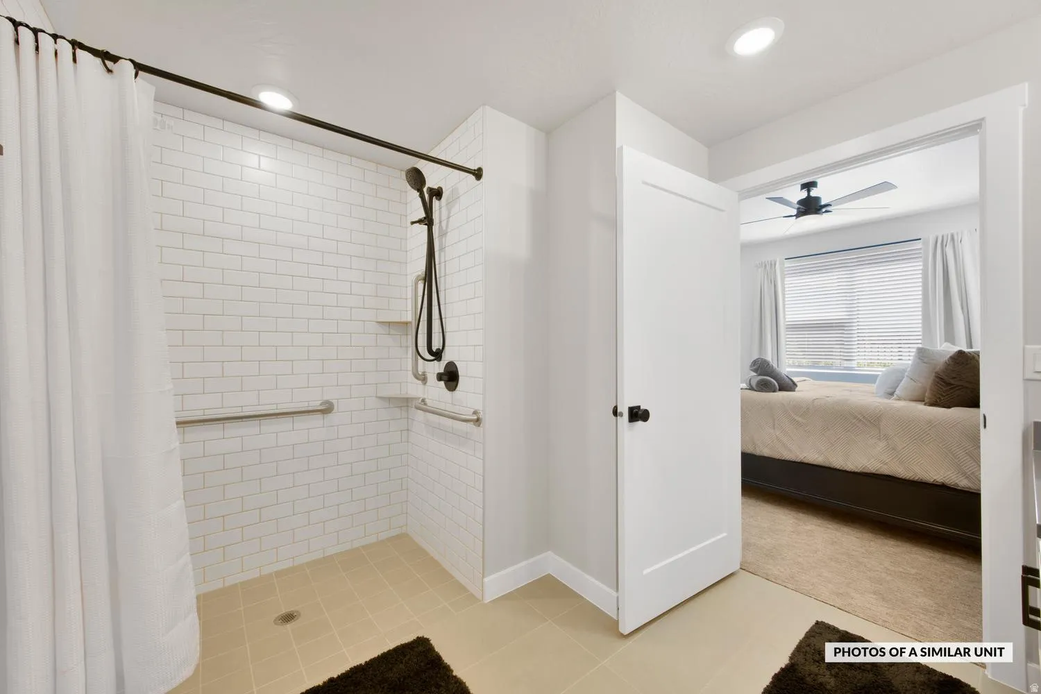 Walk-in shower featuring subway tile surround, integrated shelving, and dark bronze fixtures