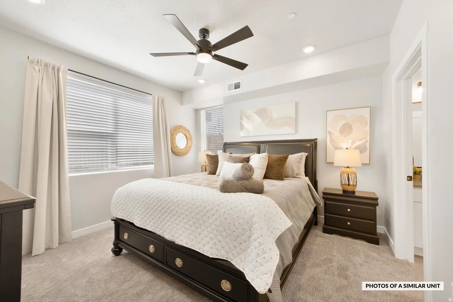 Bedroom featuring light gray walls and plush carpeting
