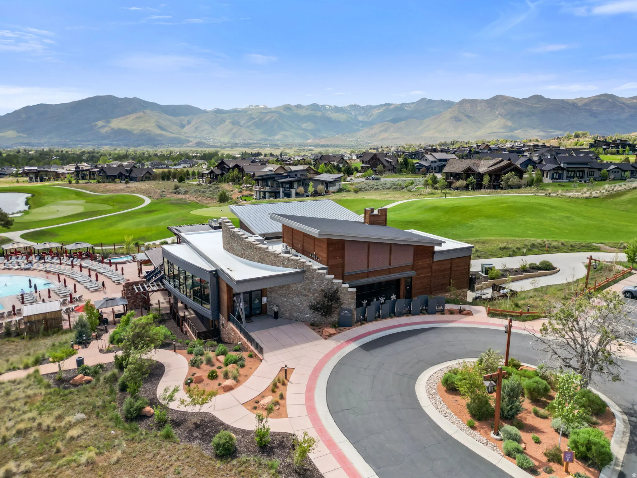 Modern club-style building with stone and wood-paneled accents