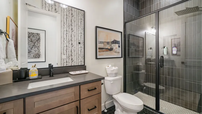 Bathroom with a wood-finish vanity, integrated rectangular sink, and matte black faucet