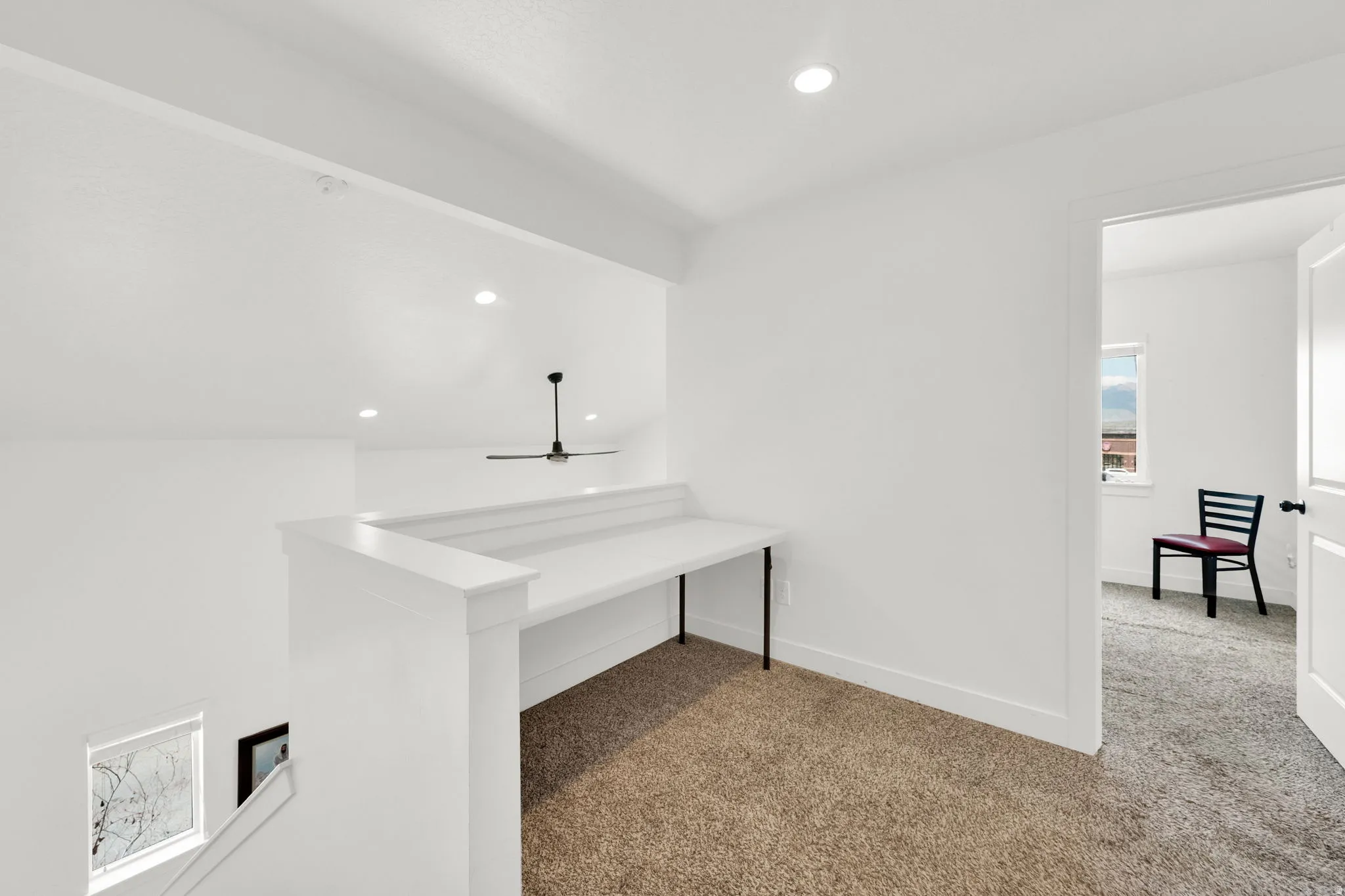 Loft area featuring a built-in desk, recessed lighting, and a ceiling fan