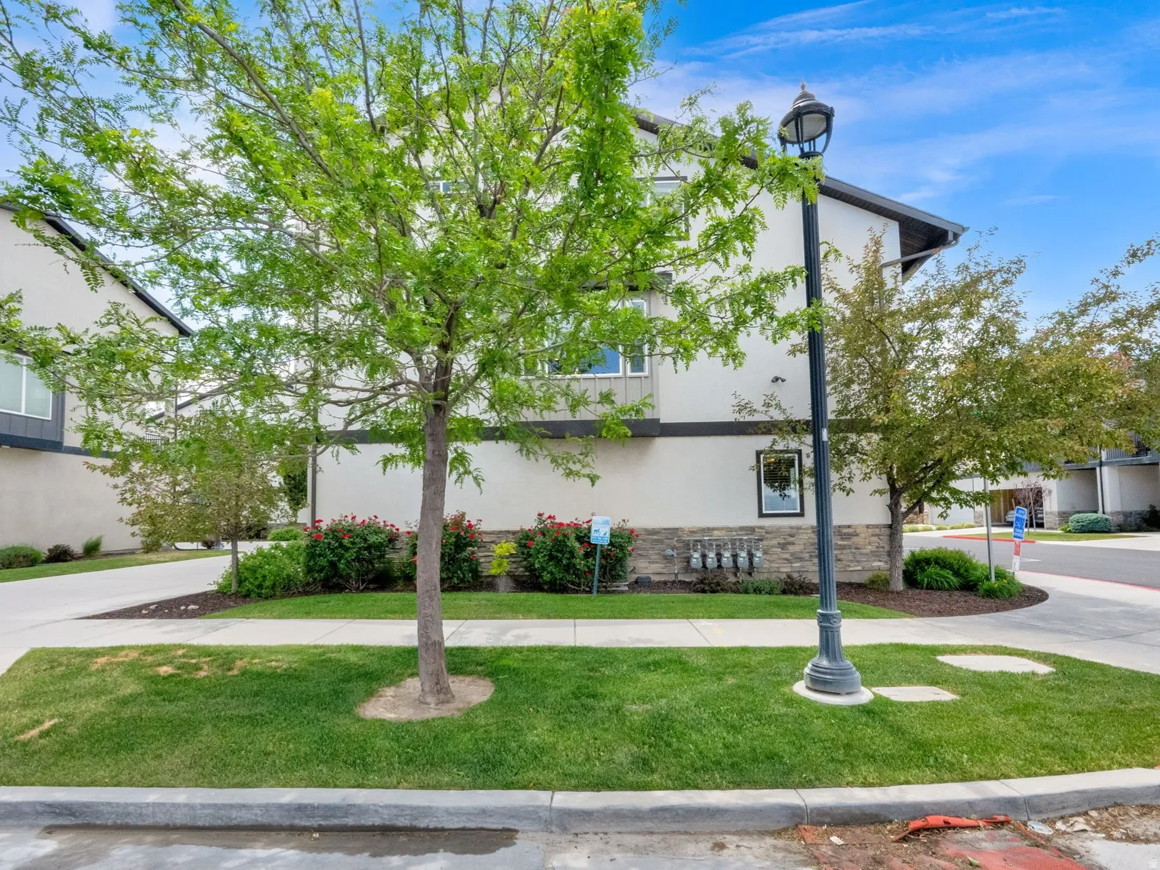 Modern townhome exterior featuring contemporary siding, stone accents, and a contrasting trim
