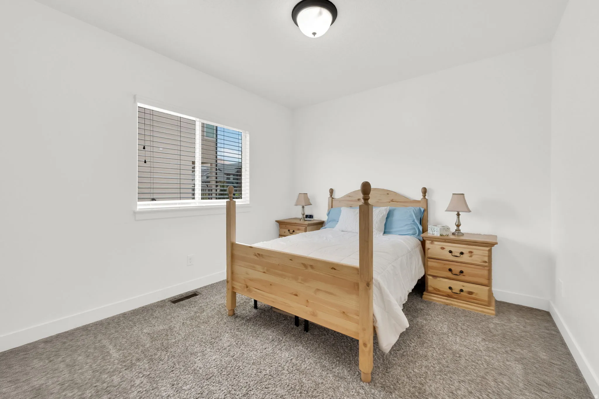 Neutral color scheme with light gray carpeting and white walls