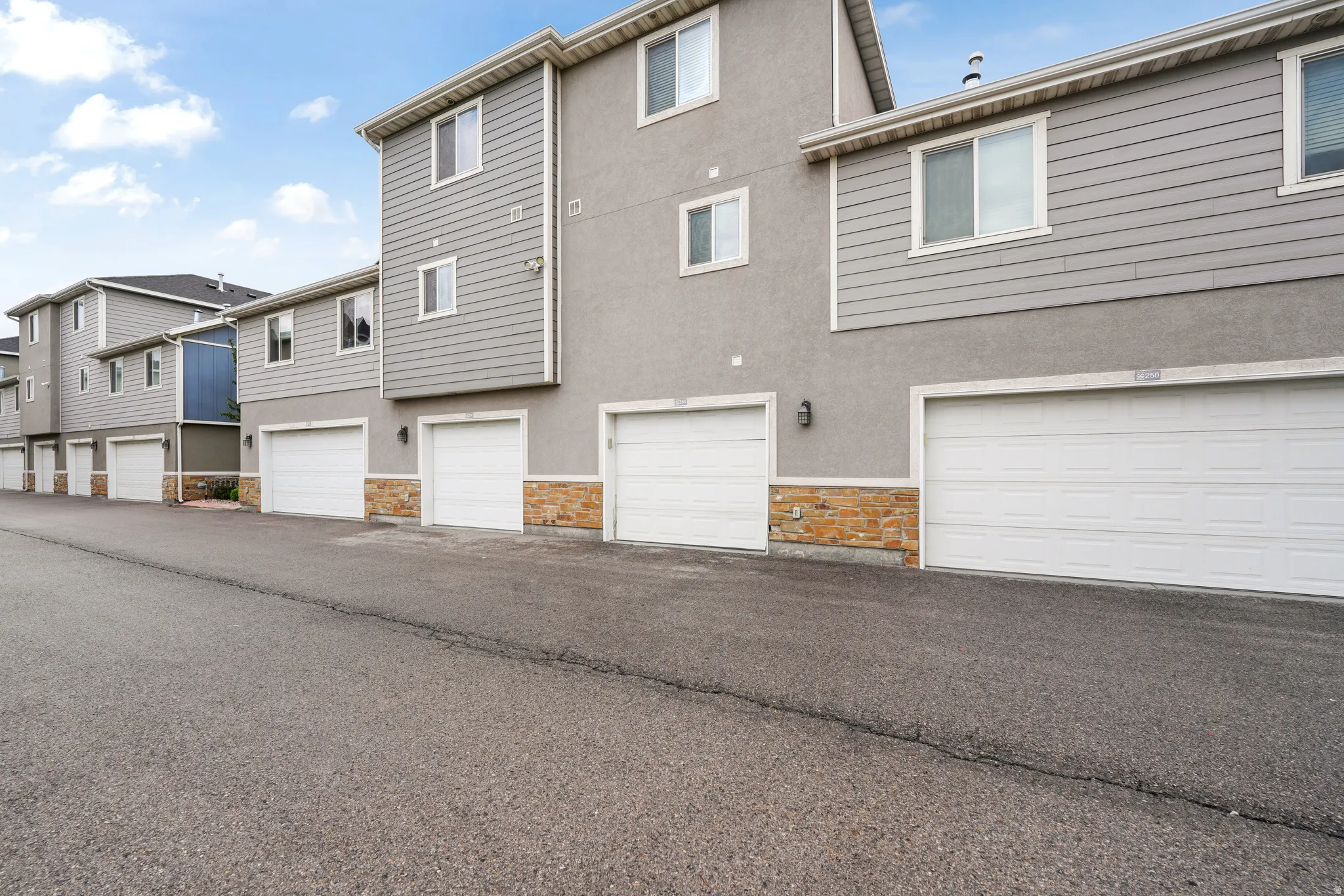 Contemporary multi-unit property with a gray stucco and siding exterior