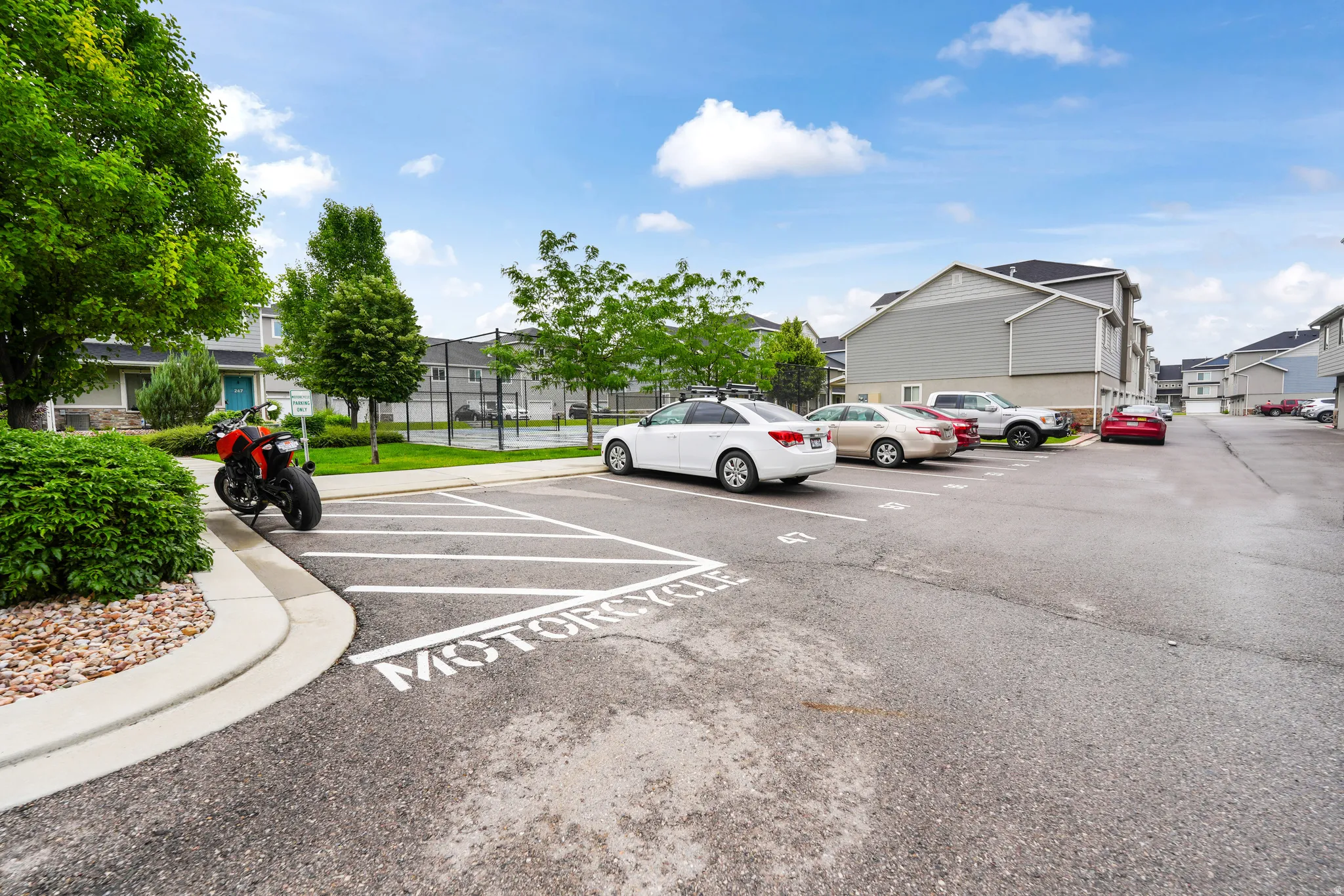 Paved parking area featuring designated motorcycle parking