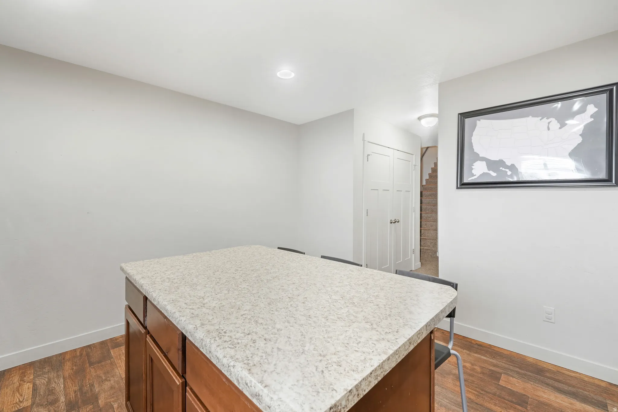 Spacious kitchen island with a light-colored countertop and wood-finish cabinetry